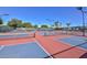 Brightly colored community tennis courts, perfect for recreation, feature lights for evening games at 19120 N 98Th Ln, Peoria, AZ 85382