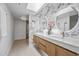 Modern bathroom with double vanity, white marble accent wall, and walk-in closet at 1925 E Lane Ave, Phoenix, AZ 85020