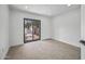 Bedroom features tile floors and a sliding glass door leading to an enclosed yard at 1925 E Lane Ave, Phoenix, AZ 85020