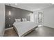 Bright bedroom featuring neutral tones, tile floors, and a door leading to the outside at 1925 E Lane Ave, Phoenix, AZ 85020