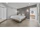 Bedroom with white bedding, tile flooring, and modern lighting at 1925 E Lane Ave, Phoenix, AZ 85020