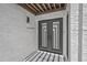 Contemporary home entrance with stylish door, textured stucco walls and artistic outdoor lighting at 1925 E Lane Ave, Phoenix, AZ 85020