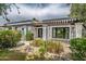 Inviting home exterior with a pergola-covered entrance, xeriscaping and modern design elements at 1925 E Lane Ave, Phoenix, AZ 85020