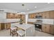 Open kitchen design featuring stainless steel appliances, light wooden cabinets, and barstool seating at the island at 1925 E Lane Ave, Phoenix, AZ 85020