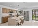 Kitchen featuring wooden cabinets, stainless steel appliances, kitchen island with barstool seating, and modern lighting at 1925 E Lane Ave, Phoenix, AZ 85020