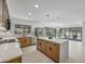 Modern kitchen boasts a central island, stainless steel appliances, and a view of the backyard through sliding glass doors at 1925 E Lane Ave, Phoenix, AZ 85020