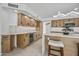 Bright kitchen featuring wooden cabinets, stone countertops, stainless steel appliances, and a kitchen island at 1925 E Lane Ave, Phoenix, AZ 85020