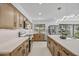 Bright kitchen featuring wooden cabinets, stone countertops, stainless steel appliances, and an island at 1925 E Lane Ave, Phoenix, AZ 85020