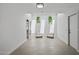 Bright sitting area with two modern chairs, hanging plants, and seamless access to the bathroom at 1925 E Lane Ave, Phoenix, AZ 85020