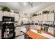 Eat-in kitchen featuring a round table, black appliances and light tone cabinets at 1943 E San Tan St, Chandler, AZ 85225