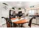 Eat-in kitchen featuring a round table, black appliances and light tone cabinets at 1943 E San Tan St, Chandler, AZ 85225