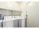 Practical laundry room with a washer, dryer and an overhead shelf for storage at 1943 E San Tan St, Chandler, AZ 85225