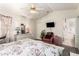 Comfortable main bedroom featuring floral bedding, ceiling fan, and ensuite bathroom at 1943 E San Tan St, Chandler, AZ 85225