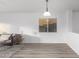 Bright living room featuring vinyl floors, white walls, and a hanging light fixture at 1952 N 103Rd Dr, Avondale, AZ 85392