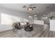 Inviting living room with wood look floors featuring modern decor and ample natural light at 1952 N 103Rd Dr, Avondale, AZ 85392
