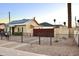 Backyard featuring a wrought-iron fence, mature trees, and an inviting exterior at 2014 N 17Th Pl, Phoenix, AZ 85006