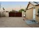 View of the expansive backyard with a large gravel area and a rustic metal gate at 2014 N 17Th Pl, Phoenix, AZ 85006