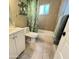 Bright bathroom with white vanity, tile flooring, a shower-tub combination and tropical-themed curtain at 2014 N 17Th Pl, Phoenix, AZ 85006