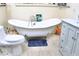 Elegant bathroom featuring a clawfoot tub, modern toilet, and a gray vanity at 2014 N 17Th Pl, Phoenix, AZ 85006