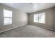Bedroom with neutral walls, carpet, and two bright windows at 2025 E Campbell Ave # 137, Phoenix, AZ 85016