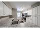 Modern kitchen with stainless steel appliances, white cabinets, and stylish granite countertops at 2025 E Campbell Ave # 137, Phoenix, AZ 85016