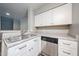 Kitchen sink and granite countertops with stainless steel dishwasher at 2025 E Campbell Ave # 137, Phoenix, AZ 85016