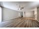 Spacious living room with ceiling fan, wood flooring, and neutral colored walls at 2025 E Campbell Ave # 137, Phoenix, AZ 85016