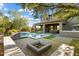 Spacious backyard with pool, playset, covered patio, and fire pit, ideal for relaxation and entertainment at 21105 N 37Th Run, Phoenix, AZ 85050
