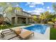Expansive backyard oasis with a pool, covered patio, playset, and lush landscaping, perfect for entertaining at 21105 N 37Th Run, Phoenix, AZ 85050