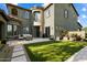 This backyard showcases well-manicured lawn with a covered patio and sleek, modern design at 21105 N 37Th Run, Phoenix, AZ 85050