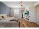 Relaxing bedroom features a ceiling fan, built in shelves, and a large window at 21105 N 37Th Run, Phoenix, AZ 85050