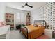 Vibrant bedroom featuring colorful butterfly wallpaper and a cozy iron bed frame at 21105 N 37Th Run, Phoenix, AZ 85050