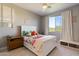Cozy bedroom with a white bed, soft carpet, and a bright window providing natural light at 21105 N 37Th Run, Phoenix, AZ 85050