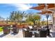 Community common area with comfortable seating, tables, and shade structures, perfect for relaxing and socializing at 21105 N 37Th Run, Phoenix, AZ 85050