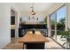 Bright dining area with a wooden table, wine fridge, and sliding glass doors to the backyard at 21105 N 37Th Run, Phoenix, AZ 85050