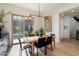 Dining room features a wooden table and sliding glass doors to the backyard at 21105 N 37Th Run, Phoenix, AZ 85050