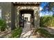 Welcoming entryway with a decorative archway and iron gate, leading to a landscaped courtyard and the home's entrance at 21105 N 37Th Run, Phoenix, AZ 85050