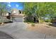 Inviting home exterior featuring a two-car garage, desert landscaping, and tile roof at 21105 N 37Th Run, Phoenix, AZ 85050