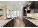 The kitchen boasts dark cabinetry, stainless steel appliances and a breakfast nook with large bright windows at 21105 N 37Th Run, Phoenix, AZ 85050