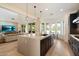 Bright kitchen features an island with granite counters, dark wood cabinets, and stainless steel appliances at 21105 N 37Th Run, Phoenix, AZ 85050