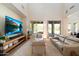 Large living room featuring a sleek entertainment center, high ceilings, and lots of natural light at 21105 N 37Th Run, Phoenix, AZ 85050