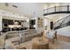 Open-concept living area showcasing a modern staircase, and seamless flow into the kitchen at 21105 N 37Th Run, Phoenix, AZ 85050