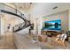 Spacious living room featuring a modern staircase, high ceilings, and a cozy seating area at 21105 N 37Th Run, Phoenix, AZ 85050