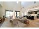 Bright living room with high ceilings and an open concept layout to the kitchen and dining area at 21105 N 37Th Run, Phoenix, AZ 85050
