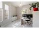 Bright office featuring a modern desk, white tile flooring, and ample natural light at 21105 N 37Th Run, Phoenix, AZ 85050