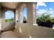 Charming outdoor patio with arched windows showcasing scenic views of the surrounding greenery at 21105 N 37Th Run, Phoenix, AZ 85050