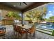 Inviting covered patio with outdoor dining, built-in grill, and view of the beautiful swimming pool and backyard at 21105 N 37Th Run, Phoenix, AZ 85050