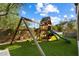 Fun backyard playset with swings, slide, and climbing structure, set on a lush green lawn at 21105 N 37Th Run, Phoenix, AZ 85050
