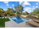 Sparkling pool featuring clean lines, a small waterfall feature, and poolside lounge chairs, perfect for relaxing at 21105 N 37Th Run, Phoenix, AZ 85050