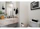 Stylish powder room featuring marble countertops, modern fixtures, and elegant decor at 21105 N 37Th Run, Phoenix, AZ 85050